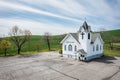 A small white church with a cross on top Royalty Free Stock Photo