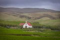 Small white church in the middle of rolling hills in Iceland Royalty Free Stock Photo