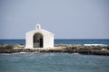 Small white church in midth of sea, crete - greece Royalty Free Stock Photo