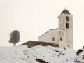 Small white church in winter in the Swiss Alps