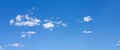 Small white clouds floating, panorama format Royalty Free Stock Photo