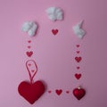 Small white clouds scatter red hearts of various sizes all over the pink background. Copy space and a flat lay scene