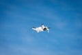 Small White Drone Flying on Blue Sky with Clouds Royalty Free Stock Photo