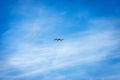 Small White Drone Flying on Blue Sky with Clouds Royalty Free Stock Photo