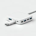 A small, white electronic hub with multiple ports including USB-A and USB-C Royalty Free Stock Photo