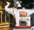 Small white elephant statue outside temple in Thailand Royalty Free Stock Photo