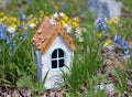 Small white fairy house in grass