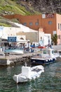 A small white fishing boat in the old port of the Greek city of Fira. Royalty Free Stock Photo