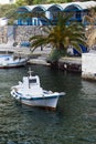 A small white fishing boat in the old port of the Greek city of Fira. Royalty Free Stock Photo