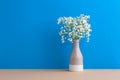 Small white flowers on a blue background. Soft home decor. Gypsophila flowers. White flowers in a vase. Retro style Royalty Free Stock Photo