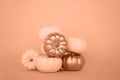 Small white and golden pumpkins of the Bebi Bu variety lie on a yellow background. The concept of harvest, Halloween, Thanksgiving