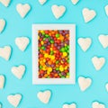 Small white hearts around the colorful frame on blue background. Love background minimal concept Royalty Free Stock Photo