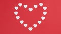 Small white hearts form a large heart shape with copy space in the center. Red background. Greeting card. Valentine`s day Royalty Free Stock Photo