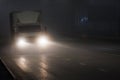 small hoodless dry van truck moving on night foggy road