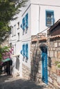 Small white house with blue windows. The narrow streets of Bodrum. Homes residents. Blue ornaments and architectural elements