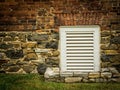 Small, White, Louvered Vent in Old Brick and Stone Wall Royalty Free Stock Photo
