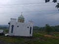 A small white mosque with the dome on the roadside Royalty Free Stock Photo