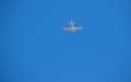 Small white plane flies in the blue sky Royalty Free Stock Photo