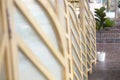 small white plant pot with artificial leaves blur foreground of room partition