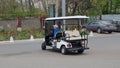 A small white pleasure car for transporting tourists