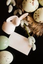 Small white rabbit figurine with easter eggs Royalty Free Stock Photo