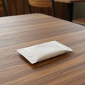 A small, white, rectangular packet, likely containing a condiment or moist towelette, Royalty Free Stock Photo