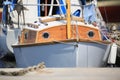 Small white sailing yacht with wooden deckhouse on a sunny day, close-up