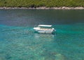 A small white ship at sea. Beautiful day and water that is blue and very clean. Royalty Free Stock Photo