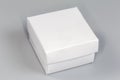 Small white square cardboard box with closed lid Royalty Free Stock Photo