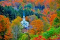 Small white steeple tucked away in the colorful green mountains HDR.