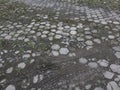 small white stone between the footrests of cement