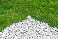 Small white stones near grass for garden decoration and flower bed background Royalty Free Stock Photo