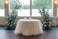Small white table for two personas and beautiful floral wedding decorations