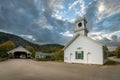 Small white church building and covered bridge in the village of Stark, New Hampshire. Royalty Free Stock Photo