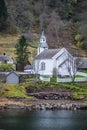 Small white wooden church on a fjord shore Royalty Free Stock Photo