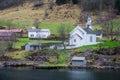 Small white wooden church on a fjord shore Royalty Free Stock Photo