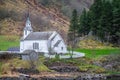 Small white wooden church on a fjord shore Royalty Free Stock Photo