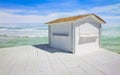 Small white wooden cottage with thatched roof by the sea Royalty Free Stock Photo