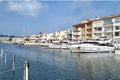 Small white yachts on the canal between city buildings. Boats on urban chanel