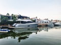 Small white yachts, on the canal between city buildings. Boats on urban chanel