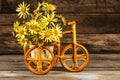 Small wicker bicycle with basket and flowers Royalty Free Stock Photo