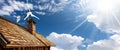 Small Wind Turbine on the top of a Roof of a Wooden Chalet - Generative Ai Royalty Free Stock Photo