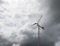The small wind turbine under the cloudy sky in the countryside farm