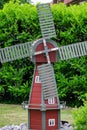 Small windmill among the trees in the garden Royalty Free Stock Photo