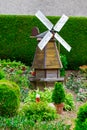 Small windmill among the trees in the garden Royalty Free Stock Photo