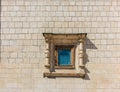 Small window in an ancient medieval wall Royalty Free Stock Photo