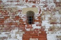 Small window with bars in the tower of the fortress wall Royalty Free Stock Photo