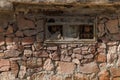 small window with broken glass and metal grate in ancient wall at sunny day, closeup full-frame background Royalty Free Stock Photo