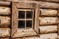 A small window in the wall of an old wooden house Royalty Free Stock Photo