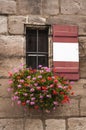 Small window with window box full of colorful flowers